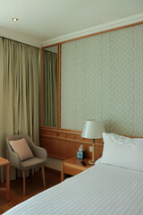 luxurious hotel room suite. bed and seating corner