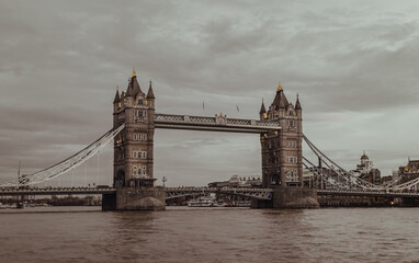 Fototapeta na wymiar Scenery view of famous Tower bridge and skyline in the river thames at evening. Vintage style, Copy space, Selective focus.