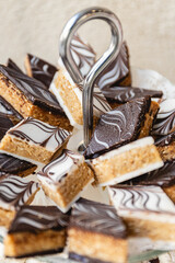 Vertical photo marbled chocolate arabic treats on elegant plate. Food and culture concept.