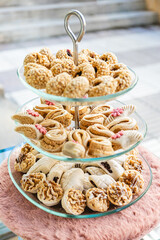 Vertical photo tiered display of assorted Arabic pastries. Food and culture concept.