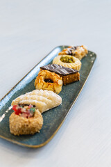 Vertical photo gourmet selection of Arabic pastries on ceramic platter. Food and culture concept.
