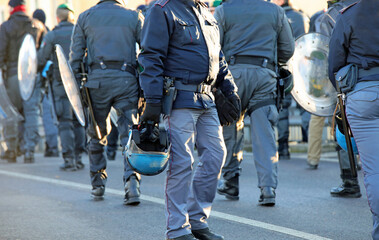 policemen in riot gear with protective helmet and truncheons during the protest demonstration