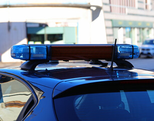 sirens of the police car with blue flashing lights during the road block