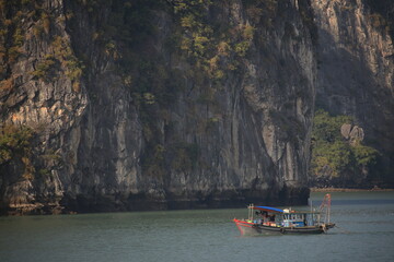 a vietnamese fishing boat in halong bay