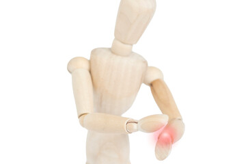 Wooden doll with pain in the wrist. Red dots representing pain. Trauma. Carpal tunnel.