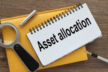 asset allocation yellow notepad with text on the page. white pen