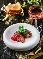Delicious meat pate foie gras on plate with berry sauce, sprouts and toasts on marble background...