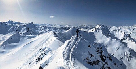 Ski tourer is out and about in a beautiful mountain landscape. Ski mountaineering in the beautiful...