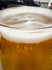 Golden Refreshment: Close-Up of a Frothy Beer Glass