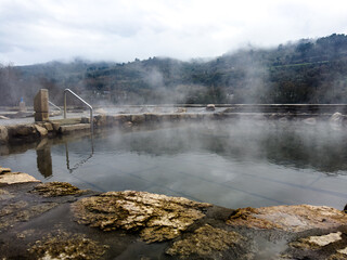Fototapeta premium Misty Thermal Spring by the Mountainside