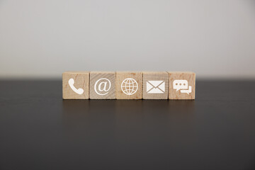 Contact us icon (phone, email, mail ) on wood cube, customer service and support for self...