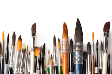 Mix of paint brushes in a row isolated on a white background.  Top view.