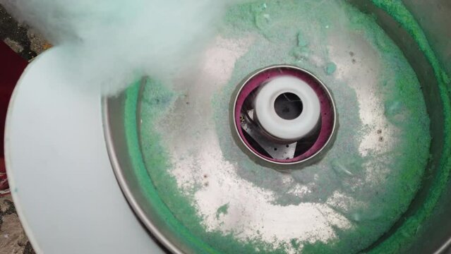 Making cotton candy or candy floss in street food market