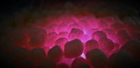 polystirene balls , pink glowing light , textured  background