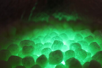polystirene balls , green glowing  light background