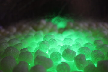 polystirene balls , green glowing  light background