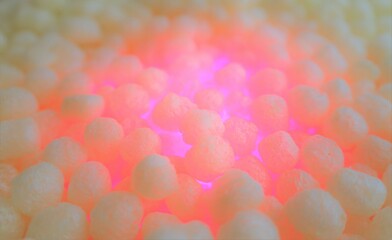 polystirene balls , pink glowing light , textured  background