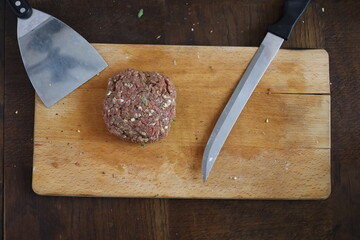 raw meat and ingredients for burger preparation