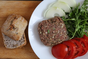 raw meat and ingredients for burger preparation