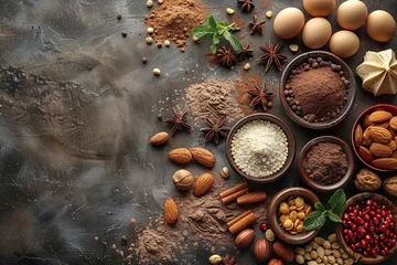 Fotobehang A variety of organic spices and ingredients, including turmeric, cinnamon, and cocoa powder, on a wooden table. © Andrii Zastrozhnov