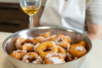 Final result of homemade tradition donuts served with a cup of wine.