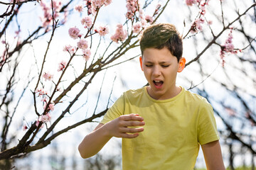 Child with pollen allergy. Boy sneezing because of seasonal allergy