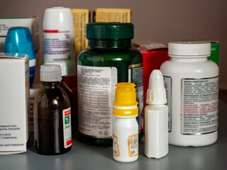 Background with medical drugs and dietary supplement. Close-up. Ophthalmic and nasal drops,...