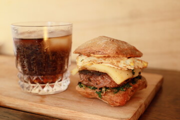 rustic burger and glass of coke