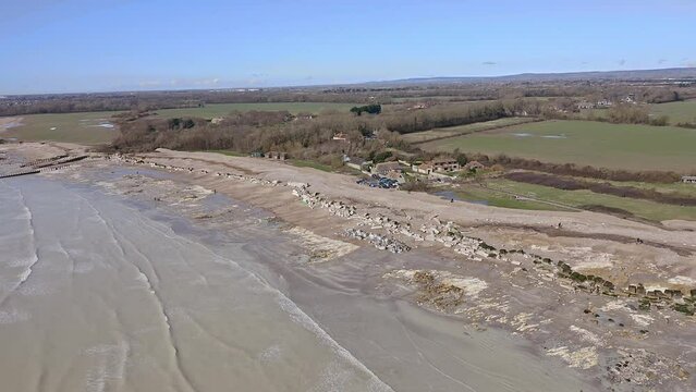 Atherington and Climping beach in West Sussex and the damaged sea defence and the temporary shingle bank in place to protect the land, aerial.