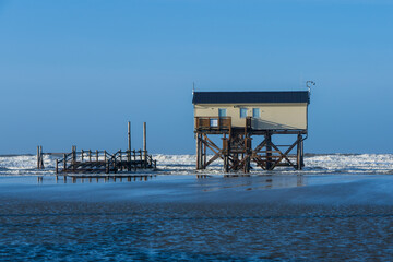 Pile dwelling on the beach of Sankt Peter-Ording in Germany.