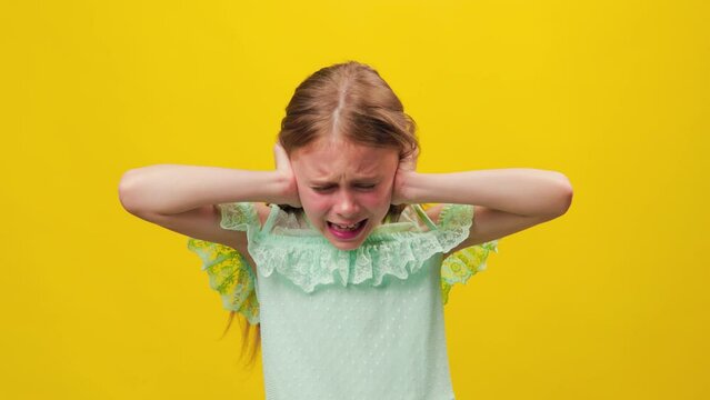 Studio portrait of displeased preteen girl screaming dramatically