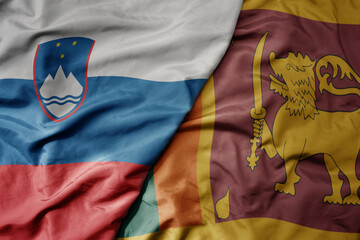 big waving national colorful flag of sri lanka and national flag of slovenia.