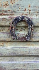 The old background. Dark worn rusty metal texture background with horseshoe.
