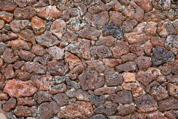 Polygonal masonry of stone wall, red stones texture