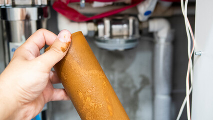 Plumber installs or change water filter. Replacement aquafilter. Repairman installing water filter...