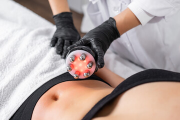 A cosmetologist expertly utilizes RF technology to conduct skin tightening and body contouring...