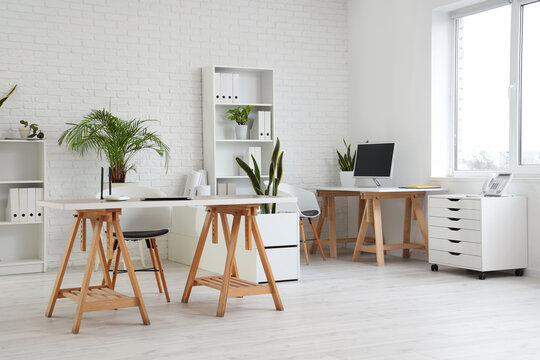 Interior of office with tables and shelf units