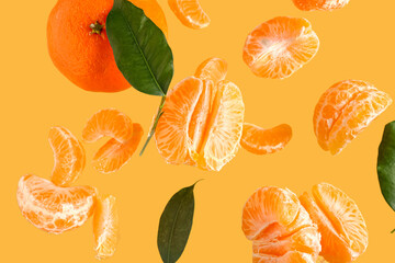 Flying sweet ripe mandarins and leaves on yellow background
