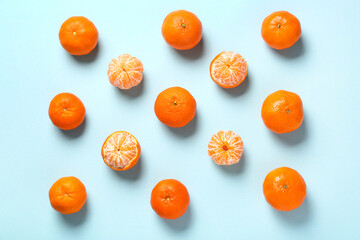 Fresh tangerines on blue background