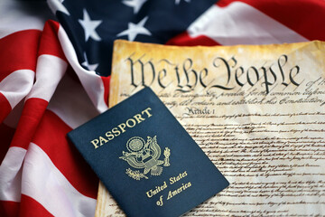 Preamble to the Constitution of the United States with passport and American Flag. Old yellow paper with We The People text