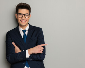 happy businessman wearing glasses pointing to side