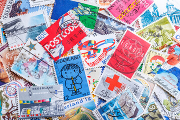 Ukraine, Kiyiv - January 12, 2023 Netherlands Postage stamps..Postage stamps.A collection of world stamps in a pile.Postage stamps from different countries and times - obrazy, fototapety, plakaty