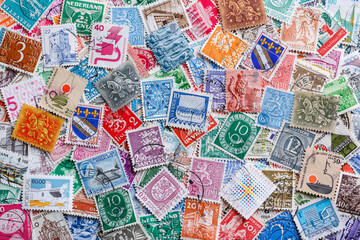 Fototapeta na wymiar Postage stamps.A collection of world stamps in a pile.Postage stamps from different countries and times