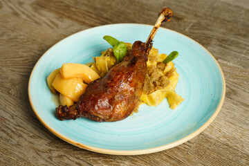 Roasted goose leg with cabbage papardelle pasta and quince compote