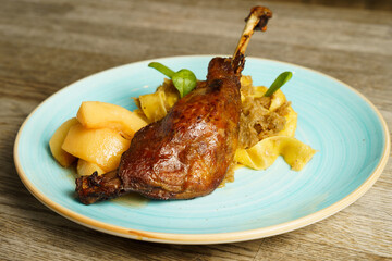 Roasted goose leg with cabbage papardelle pasta and quince compote