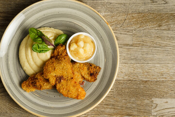 Fried fish with mashed potatoes and quince apple jam