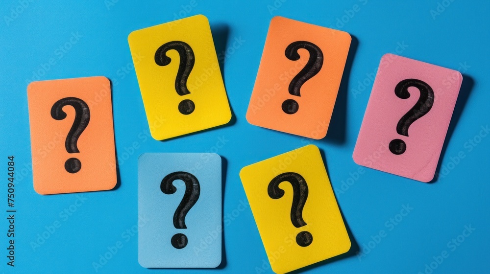 Poster four pieces of colored paper with a question mark in the middle of them on a blue and pink backgroun
