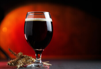 glass of dark stout is on the table. Craft beer