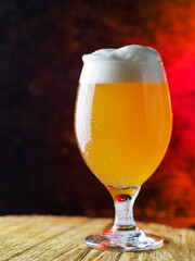 glass of cold craft beer on a wooden table with copy space