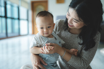 Portrait of enjoy happy love family asian mother playing with adorable little asian baby newborn...